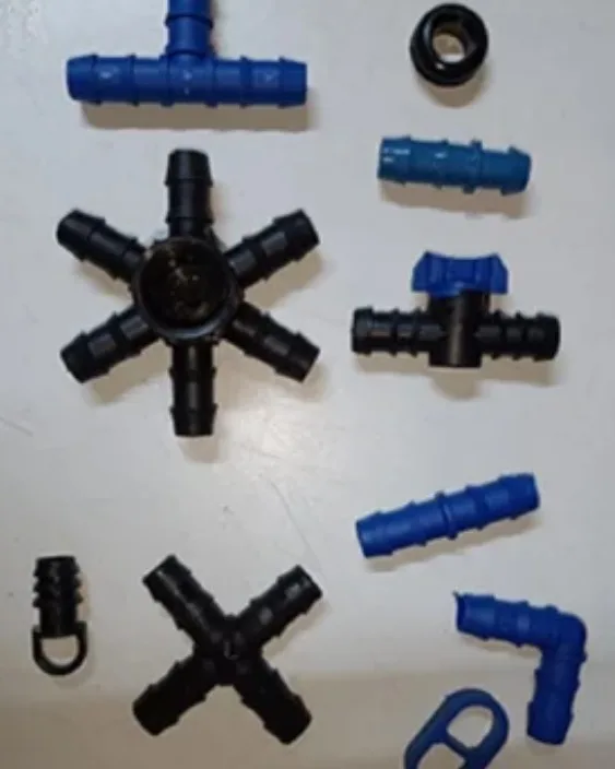 Barbed tee, cross and elbow fittings used to join the piping network