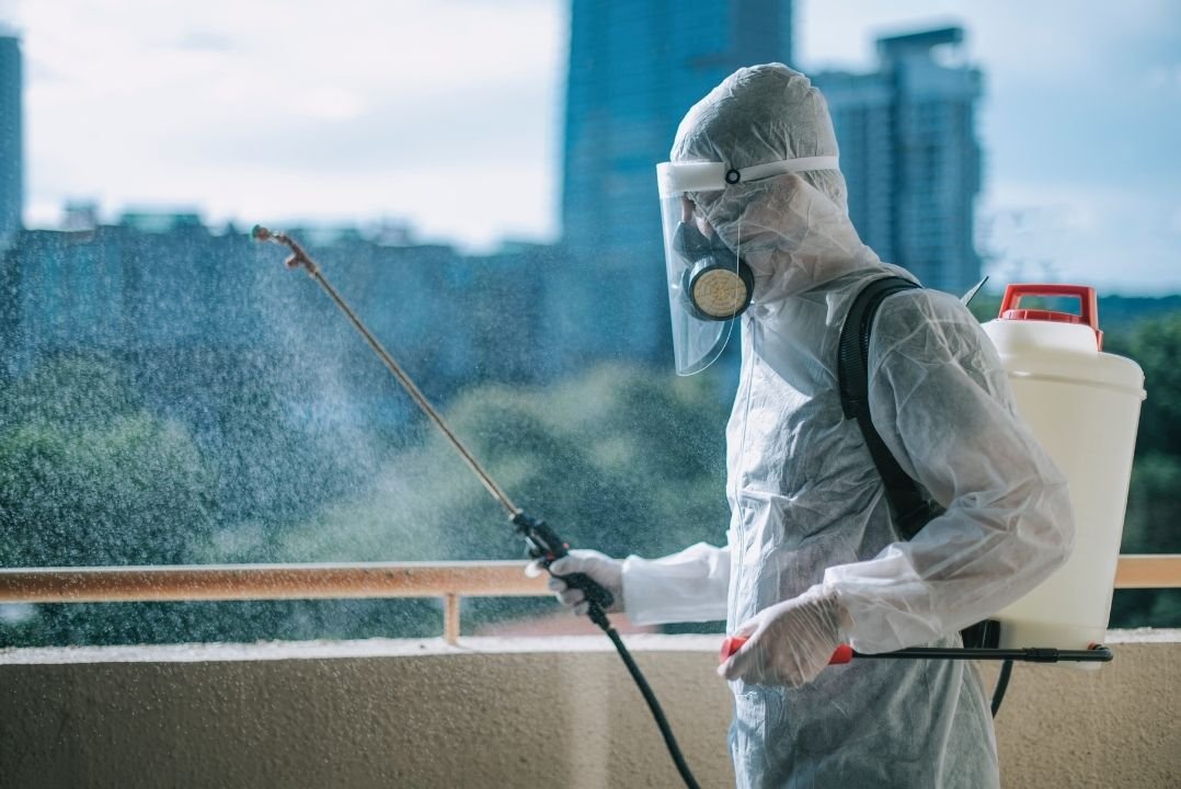 The Pest Management technician fogging a Chennai rooftop terrace for mosquito control